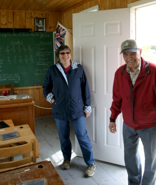 Germaine Prybysh and Lucien Croteau step inside a replica of the Durlingville School at the Bonnyville &#038; District Museum on June 3.