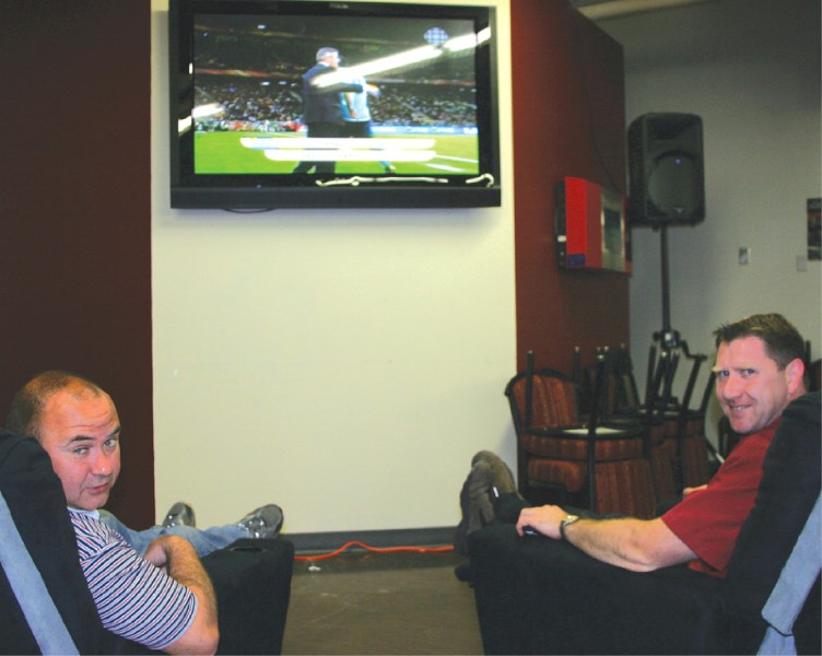 Dave Cowan (left) and Keith Durie enjoy World Cup action featuring France and Uruguay on Friday afternoon.
