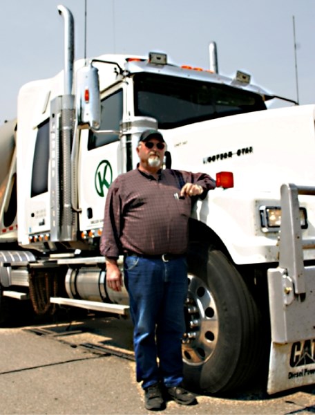 Ken Krohn from Edmonton stops at the Hoselaw vehicle inspection station June 18 for a quick bite before hitting the road to Cold Lake.