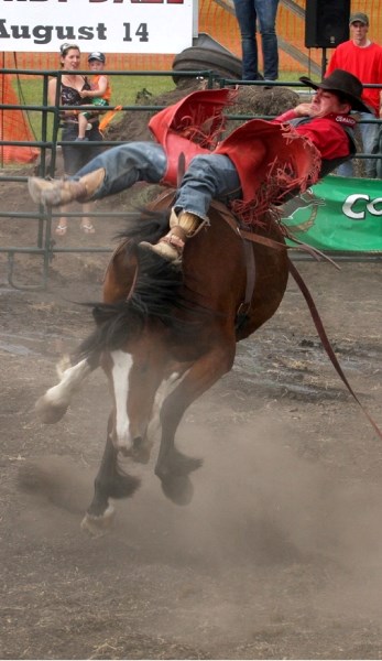 Kevin Langevin of St. Lina hangs on for a 70 in the preliminary bareback round at the Glendon Rough Stock Rodeo on Saturday night.