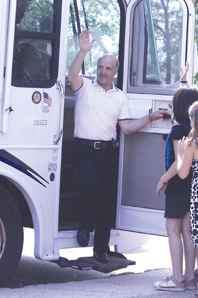 Retiring Duclos School principal Walter Ogrodiuk waves farewell to staff and students at Duclos School before &#8220;officially&#8221; departing in his motorhome with his