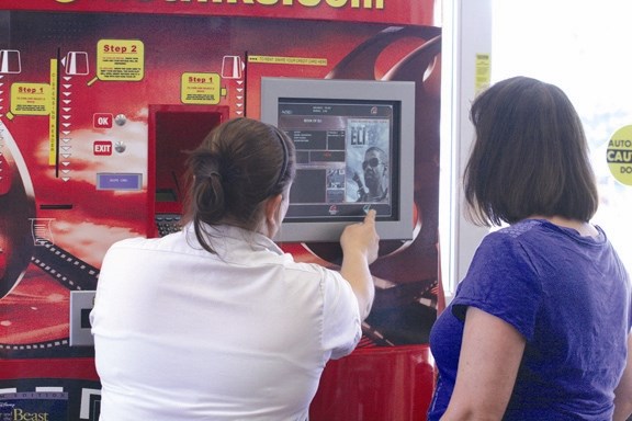 Sobeys&#8217; employee Jennifer Vasseur (left) shows Carmen Wurst how to operate the DVD vending machine inside Sobeys on July 8. With the demise of the two video stores in