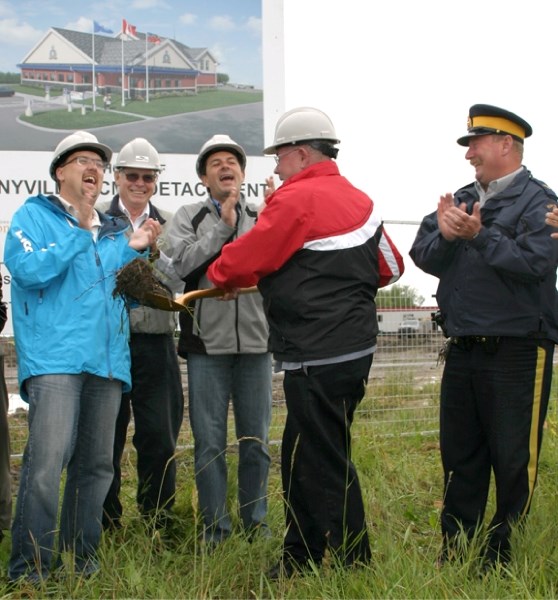 Mayor Ernie Isely turns the sod at the site for the new RCMP headquarters at 46th Street and 54th Avenue on July 13. MP Brian Storseth (left) MD Councillor Delano Tolley,