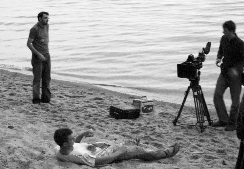 From left: Michael Wheeler, (camera assistant), Caleb Fischer (playing Trent on beach) and Kalon McClarty (director of photography) film the movie The Corrupted on the shores 