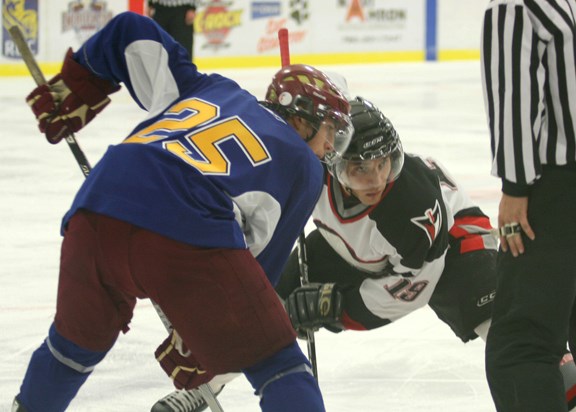 A Pontiacs forward faces off against a center for the Oil Barons. The Pontiacs eventually lost the August 25 exhibition game.