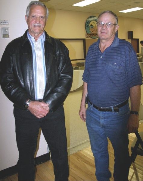 Fred Bamber (left) and Glen Johnson visit with residents at the Shell Orion project open house on Oct. 19. Bamber won his first election to MD council for Ward 6, while