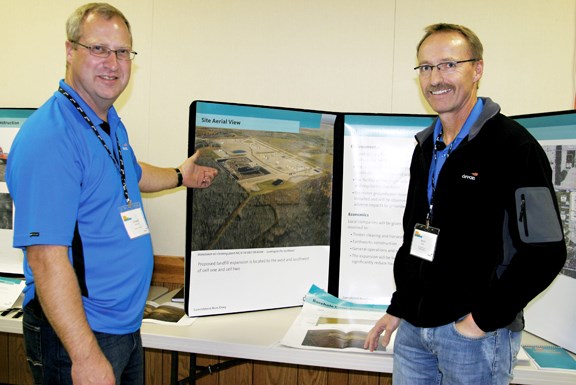 Armand Amyotte (left), production foreman, and Kevin Ryan, district superintendant, talk to the public about Devon Canada&#8217;s proposed landfill expansion.