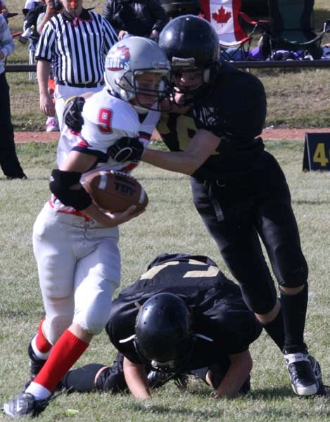 Bandits running back Caleb Fagnan picks up a few extra yards on the run, holding off a Cold Lake Royals defensive back, during the Bandits&#8217; third game of the season.