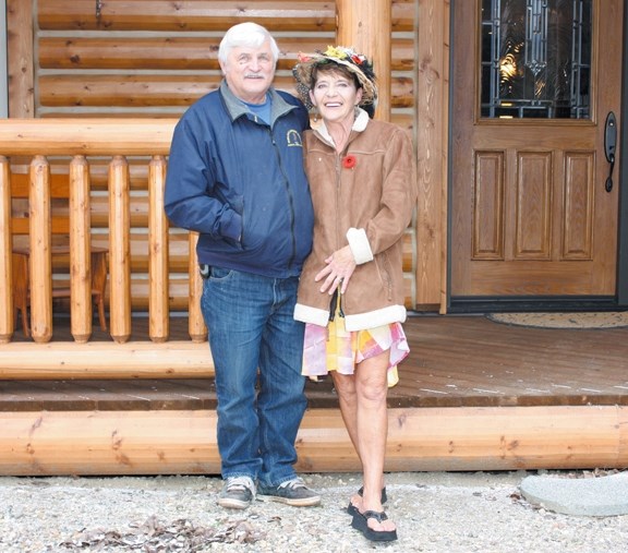 Johnnie Doonanco and his wife Mary in front of their log cabin in Glendon. Doonanco has served the community of Glendon for 39 years as mayor.