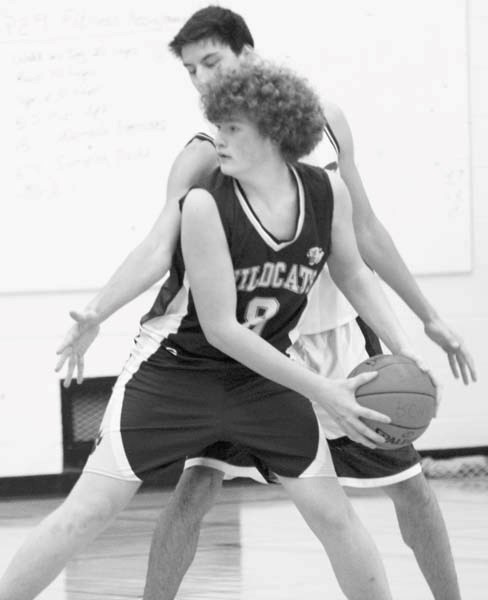 NDHS player Dawson Hamel is guarded by a BCHS player during their first regular season game at BCHS Dec. 8. BCHS won the game in a blowout 72-30.