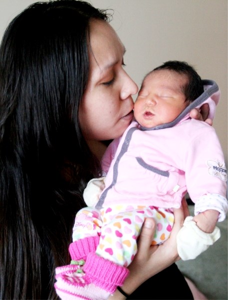 Angela (Angel) Janvier embraces her newborn baby, Kennedy Mayanna Payton Janvier, who was born at 11:10 a.m. Jan. 1. Kennedy was the first baby born of the year at the