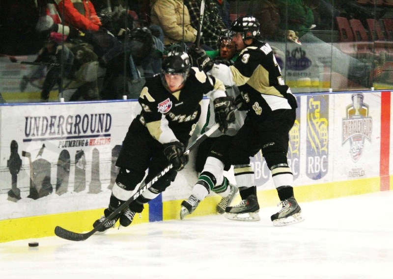 Pontiacs defenceman Jordon Krankowsky crushes a Drayton Valley player, while Blake Leask picks up the loose puck and breaks into the zone. The Pontiacs beat Drayton Valley
