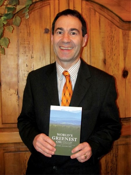Author Peter Silverstone poses with his book, World&#8217;s Greenest Oil, before a talk at the Shaw House last Thursday.
