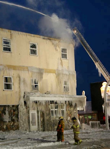 Firefighters work on putting out the fire at the Bonnyville Hotel in December.