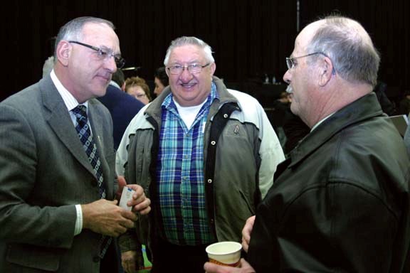 Minister of Municipal Affairs, Hector Goudreau, (left) talks with Glendon councillor William Moleschi and Mayor Larry Lofstrand after presentations by cabinet ministers at