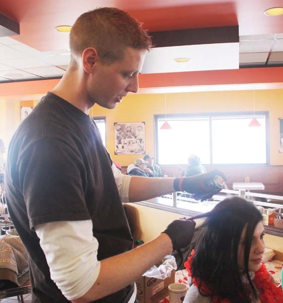 Organizer James Purdy streaks Leah D&#8217;abadie&#8217;s hair at the MS Walk registration March 12.