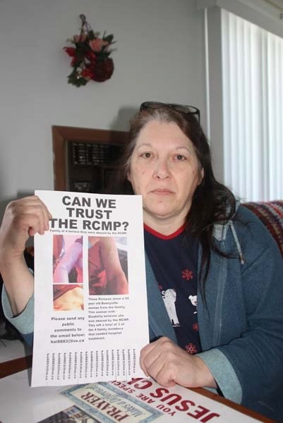 Bonnyville&#8217;s Lucina Pollock holds up the poster she and members of her family distributed across town last week. Pollock says she, her son and grandson were victims of