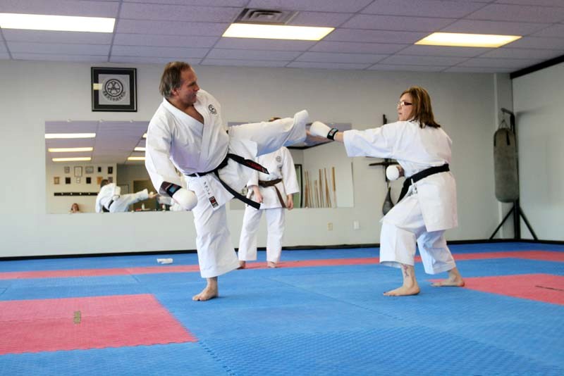 Irene Welecki fends off a kick from Sensei Carry Grant during a kumite sparring match at the Bonnyville Karate-Do April 6.