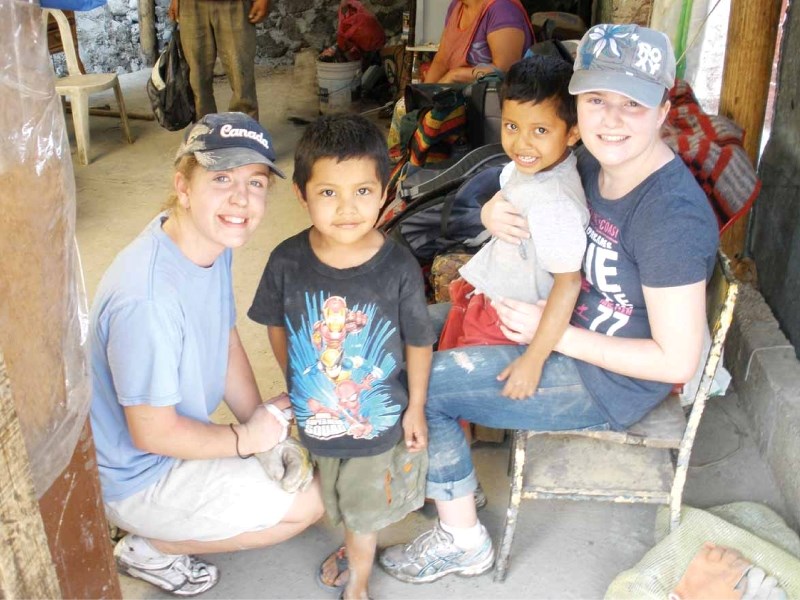 Students from the Bonnyville area and the friends they met in Mexico take shelter in the shade.