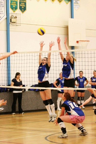 Players from the U16 Sharks go up for the block against the U18 Sharks during a game this past week.
