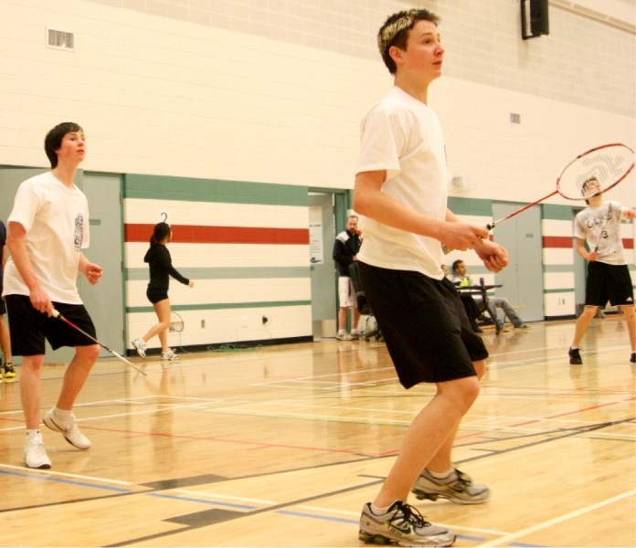 Notre Dame High School students Steenn Pasichnuk (right) and teammate Mitchell Hebert (left) watch as their shot falls in on their opponent at badminton districts last month. 