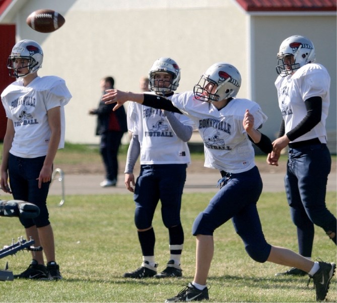 Voyageurs quarterback Jerad Churko fires a pass to a teammate during spring season practice May 11.