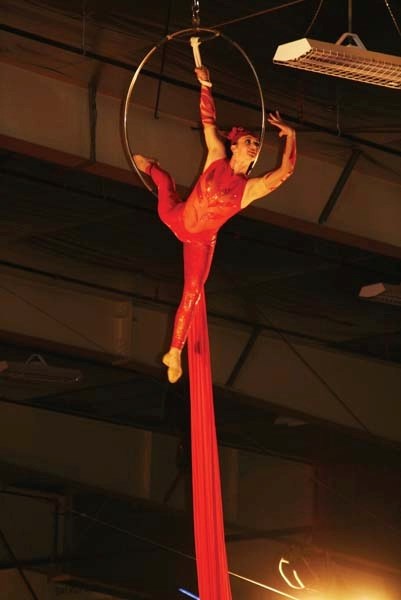 An aerial silks artist hangs from a ring during the Circus Gatti performance at the Centennial Centre this past Sunday.