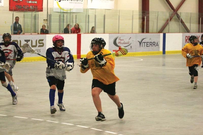 Lakeland Heat player Colby Gulutzan carries the ball past the Vermilion defender during the lacrosse game at the Centennial Centre this past week.