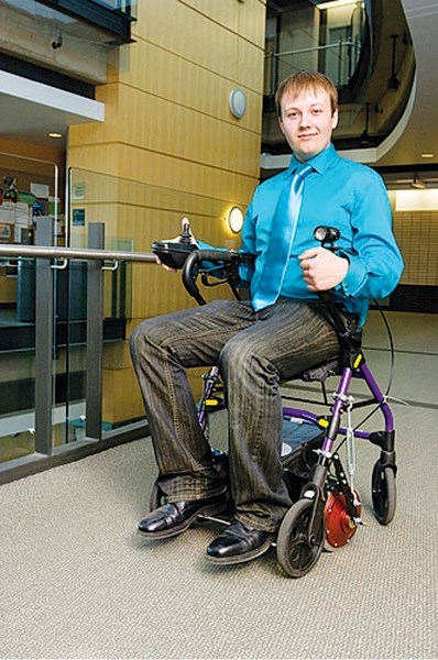 Gary Kurek sits on a walker coverted to a multifunctional wheelchair combination using the kit he invented.