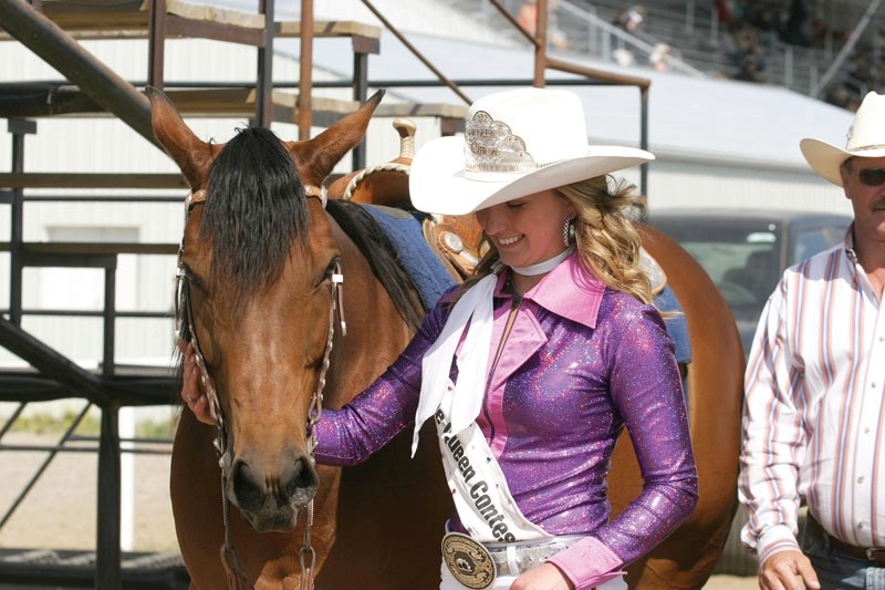 Queen Ashley Hayward walks with her horse right after being named BPRCA queen at the rodeo.