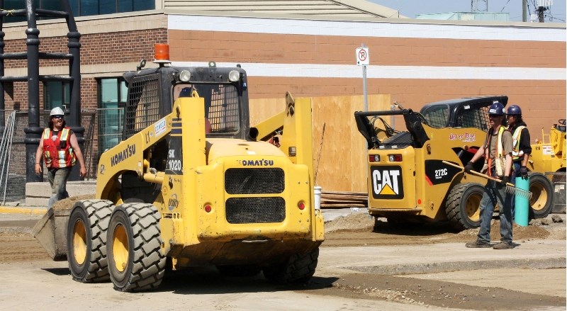 Workers finish up construction on the road in front of the MD of Bonnyville office Thursday.