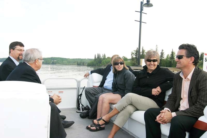 (Far left) Deputy Bonnyville Mayor Gene Sobolewski and (far right) Cold Lake Mayor Craig Copeland escort the 2015 Summer Games delegation on a boat tour of the Cold Lake