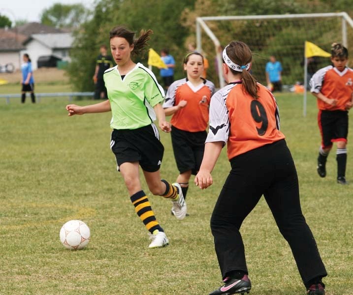 The Bonnyville Thunder player (left) carries the ball past the defenders during the U12 Wetlands Tournament in Bonnyville this past Saturday.