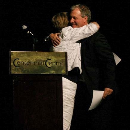 MLA Genia Leskiw hugs her colleague and friend, Ron Liepert, Minister of Energy, at the Oil and Gas Show on June 22, after introducing him.