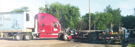 A semi truck drove through a stop sign Wednesday at the LaCorey intersection and caused a collision which held up traffic for about an hour.
