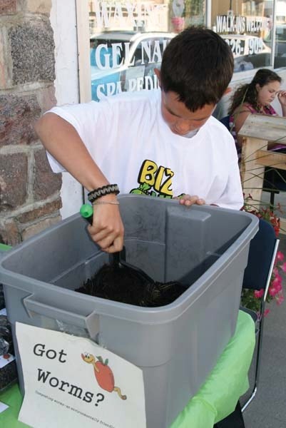 Got Worms? business owner Steven Sawchuk digs for some composting worms to show a customer at the Biz Kids business display in front of Community Future Lakeland in