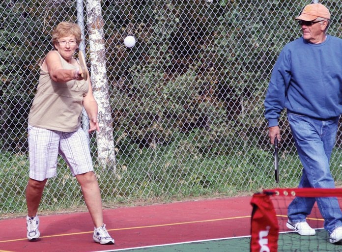 Pickleball player Terry Voth returns the ball, while fellow pickleball player Bob Hornseth looks on during a game at Pelican Narrows Summer Village Aug. 31.