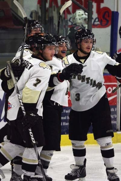 Pontiacs forward Paul Lamoureux (middle, blue mouthguard) celebrates the game&#8217;s first goal against the Lloydminster Bobcats Tuesday. The Pontiacs beat the Bobcats 2-1