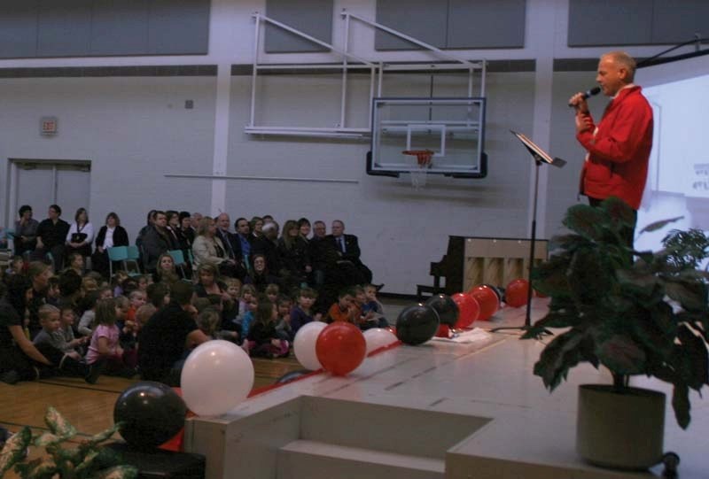 Principal Richard Cameron explains the history of Duclos School to gathered students, parents, and honoured guests during a grand opening celebration held inside the