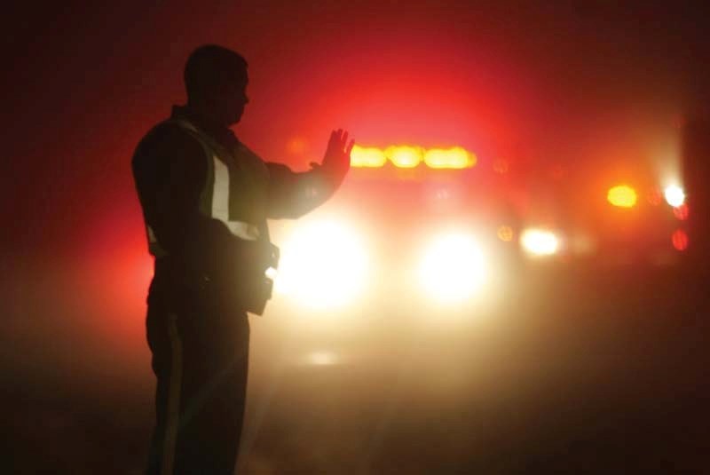 A police officer directs traffic in the fog on Highway 28 after a collision between two trucks which claimed the life of a Bonnyville citizen. File photo 2018.