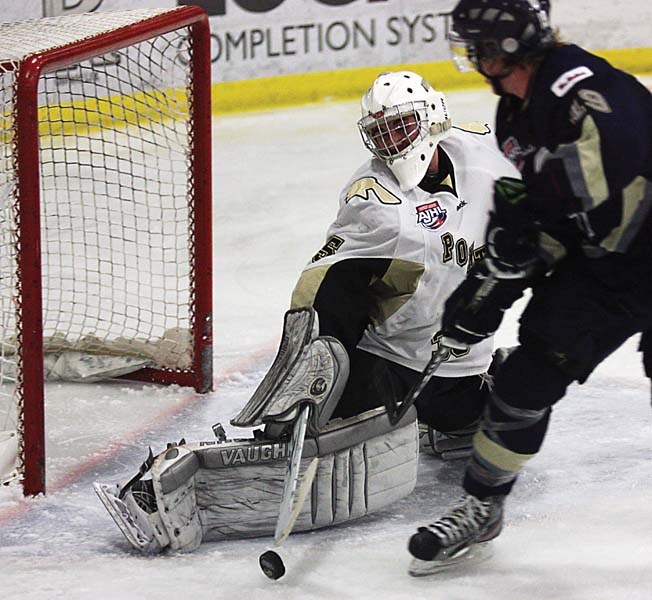 Pontiacs goaltender Curtis Honey makes a stick save on Saints forward Nolan Huysmans. Honey made 28 saves in a 4-3 overtime loss Tuesday in Bonnyville.