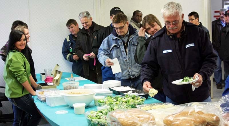 Organizers of a BBQ fundraiser held at the Husky&#8217;s Tucker plant on April 25 present Christine Whyte with a $4,546 donation, which will go toward the purchase of a