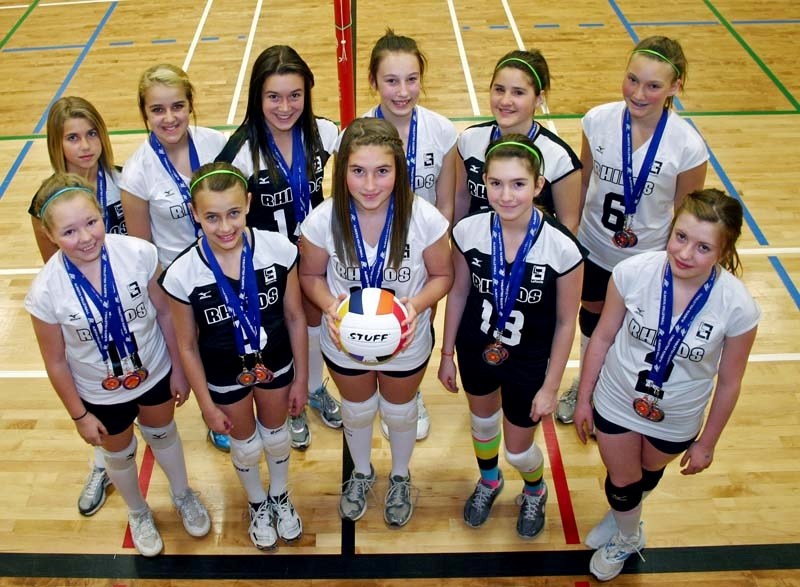 The U13 Rhinos club volleyball team shows off medals from this past season. The Rhinos captured silver and bronze medals at the first and second premier tournaments and then
