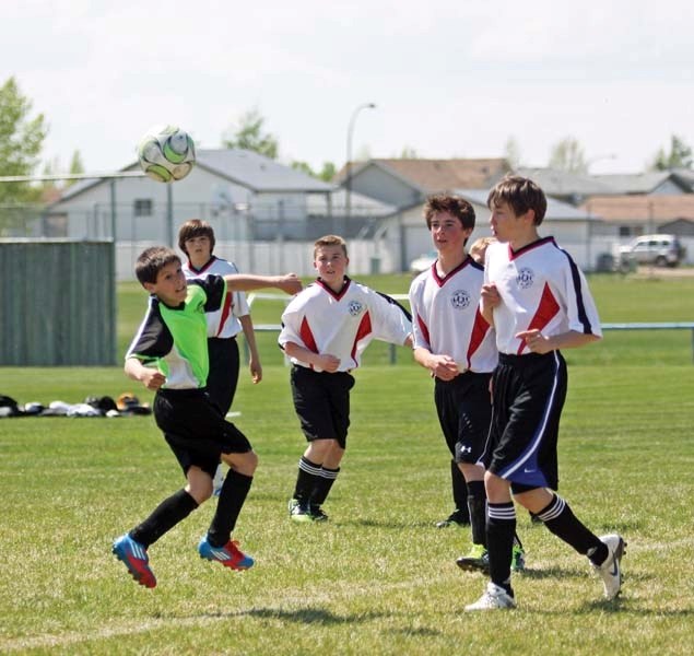 The Bonnyville player heads the ball to his teammate, as his opponents cover him during the U14 soccer match between Bonnyville and Vegreville this past weekend in Bonnyville 