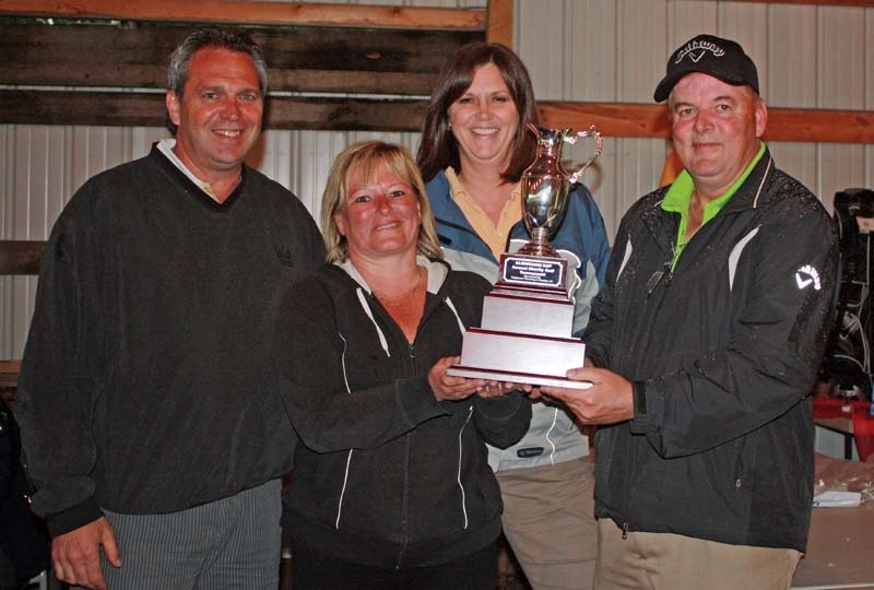 The winning team at the first ever Kleinmann Cup Charity Golf Tournament celebrates with the trophy after putting up the best score in the Texas Scramble event this past