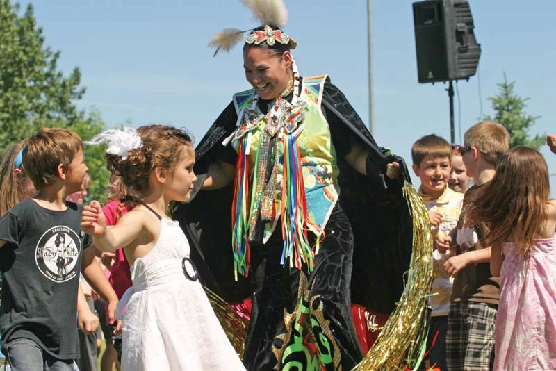 After demonstrating a variety of dances, the dancers invite children from the crowd to take part and learn the steps.