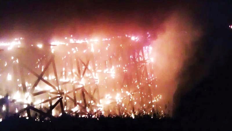 Flames engulf much of the north end of the Beaver River trestle early this past Friday morning. Fire crews were still on scene Monday morning extinguishing any remaining hot