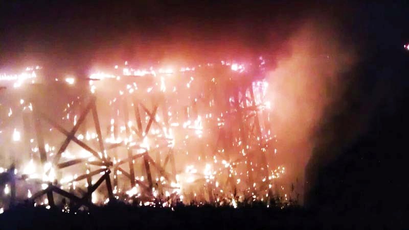 Flames engulf much of the north end of the Beaver River Trestle bridge.