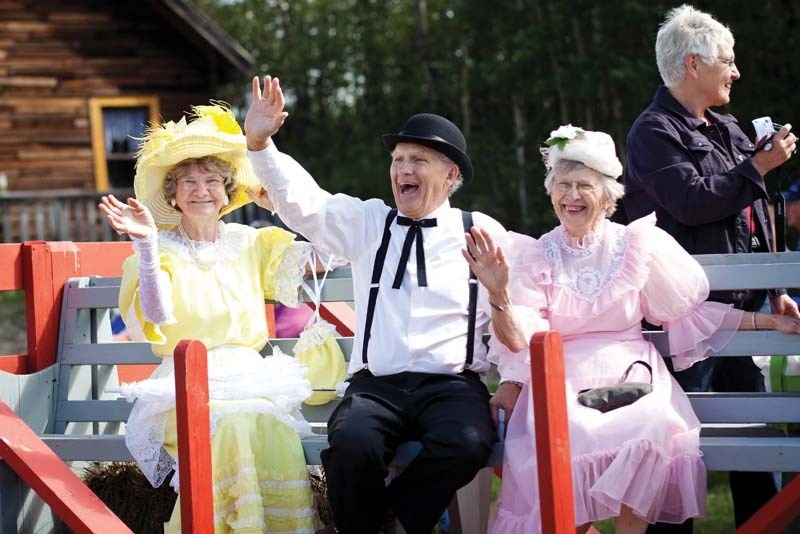 Participants in the Haying in the 30&#8217;s parade wave on Aug. 4. This year&#8217;s Haying in the 30&#8217;s event raised about $197,000, attracting the biggest crowd yet.