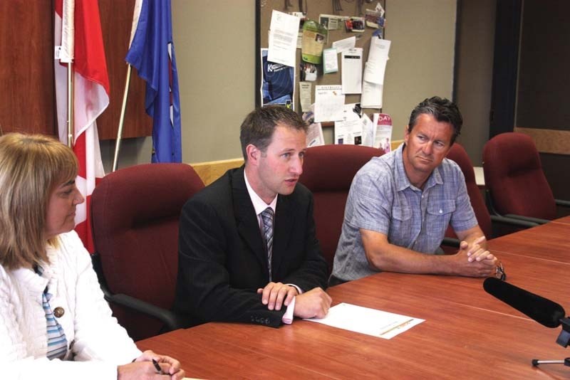 Const. Dan Kehler (middle), of the general investigations unit of the Cold Lake RCMP, announces the arrests of three individuals in relation to the arson that caused damage